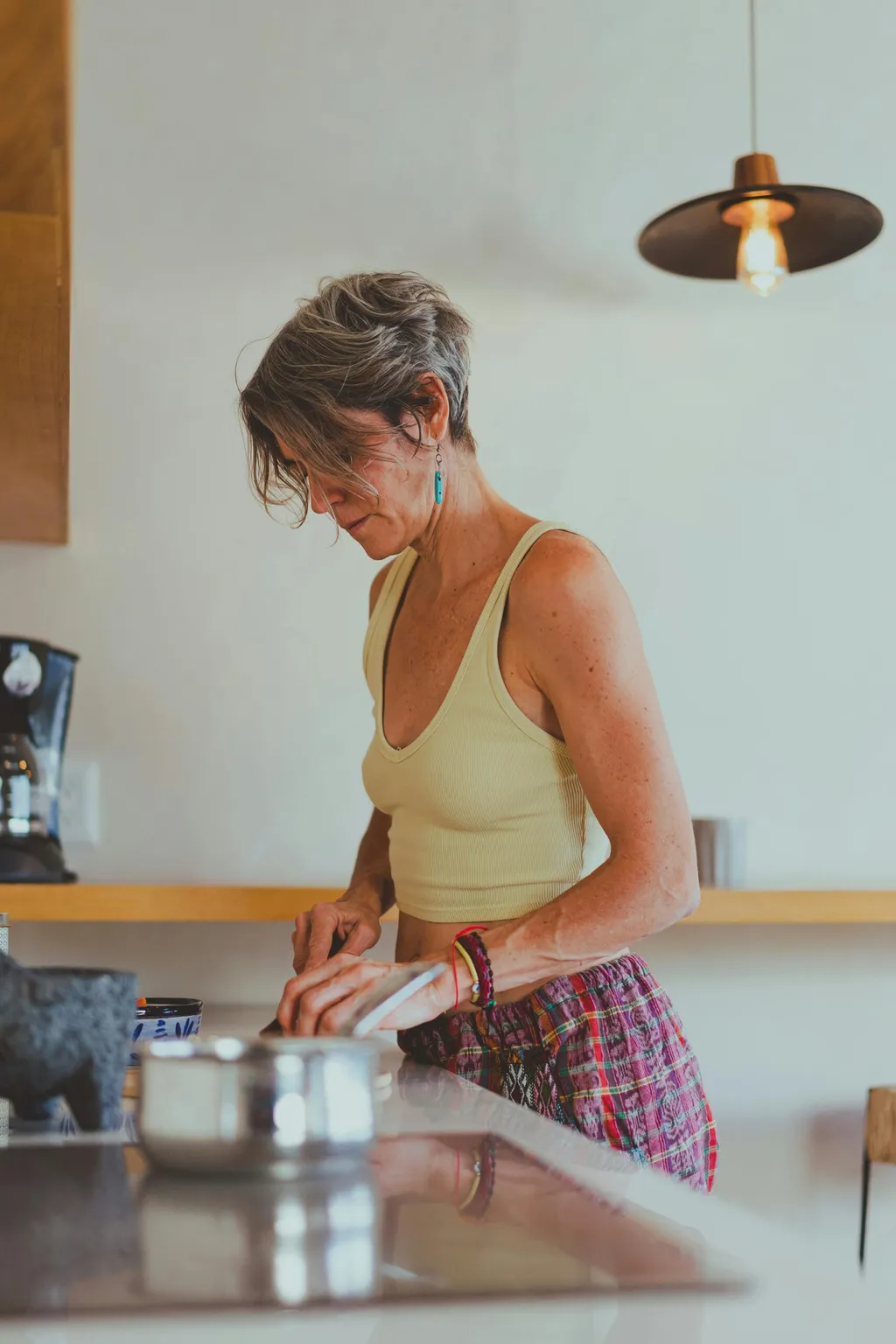 Woman preparing food at her kitchen counter